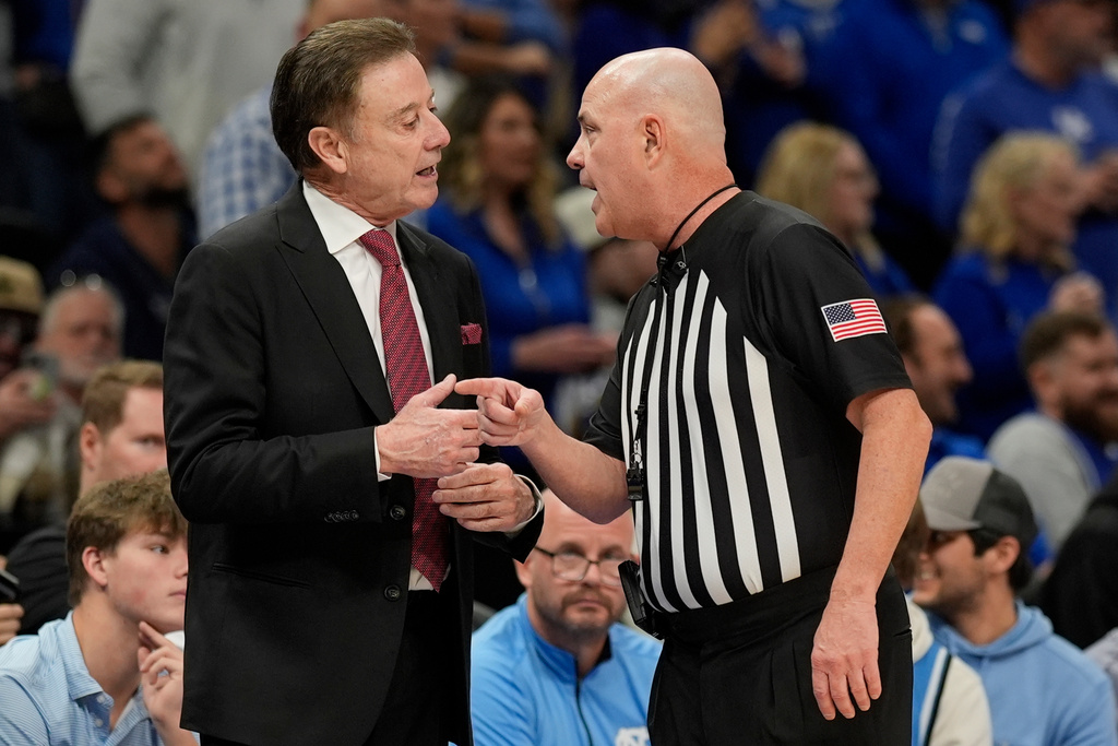 St. John's head coach Rick Pitino speaks with an official during the first half of an NCAA basketball game against Kentucky, Saturday, Dec. 20, 2025, in Atlanta. (AP Photo/Mike Stewart)