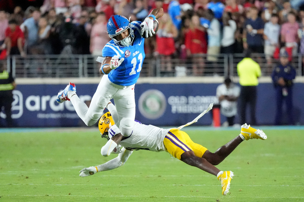Mississippi wide receiver Horatio Fields (11) is upended by LSU cornerback PJ Woodland (11) during the first half of an NCAA college football game in Oxford, Miss., Saturday, Sept. 19, 2026. (AP Photo/Rogelio V. Solis)