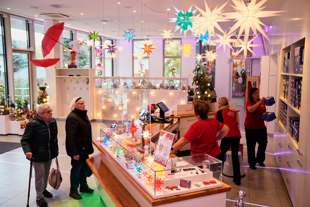 People visit Herrnhuter Sterne GmbH manufacturing, a Christmas stars manufacturing company in Herrnhut, Germany, Nov. 10, 2025. (AP Photo/Ebrahim Noroozi)
