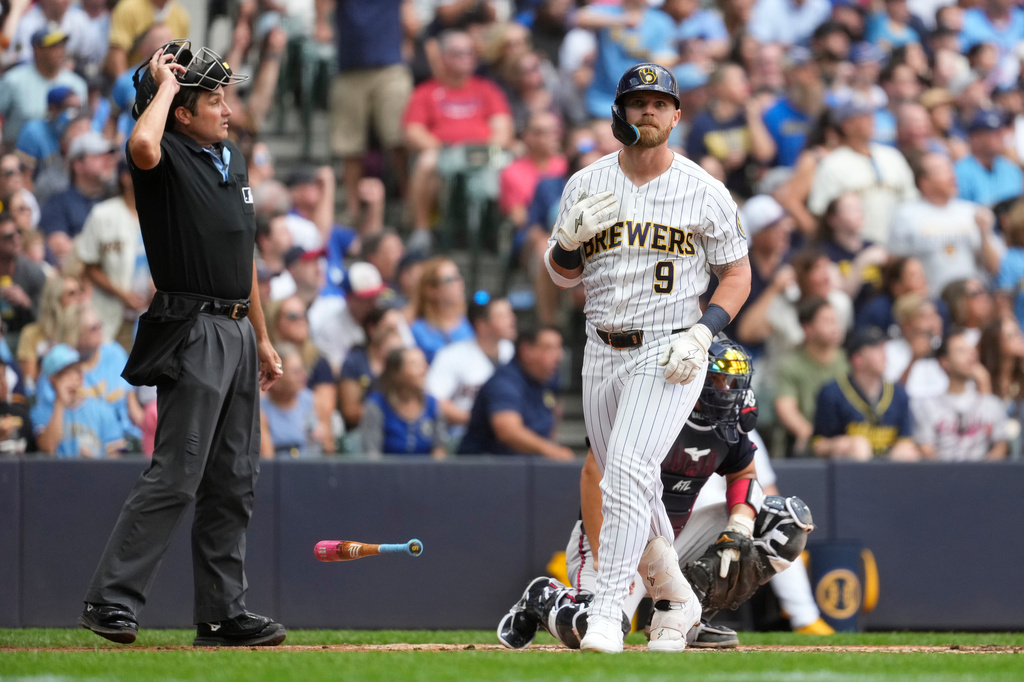 Milwaukee Brewers' Jake Bauers flips his bat after hitting a two-run home run during the third inning of a baseball game against the Atlanta Braves, Saturday, Aug. 22, 2026, in Milwaukee. (AP Photo/Aaron Gash)