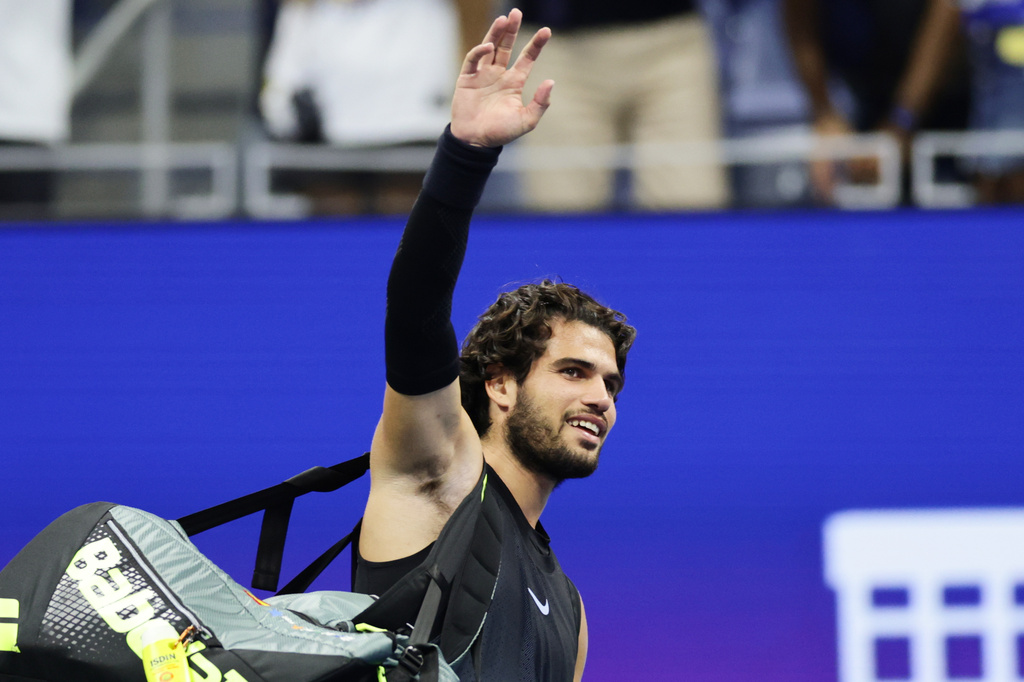 Carlos Alcaraz, of Spain, acknowledges the fans after losing to Ben Shelton, of the United States, in the quarterfinal round of the U.S. Open tennis championships, early Wednesday, Sept. 9, 2026, in New York. (AP Photo/Adam Hunger)