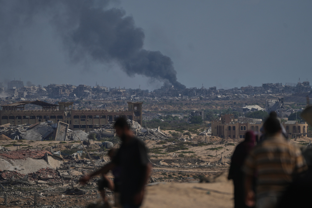 Smoke rises to the sky following an Israeli military strike in Gaza City, as seen from the central Gaza Strip, Thursday, Oct. 2, 2025. (AP Photo/Abdel Kareem Hana)