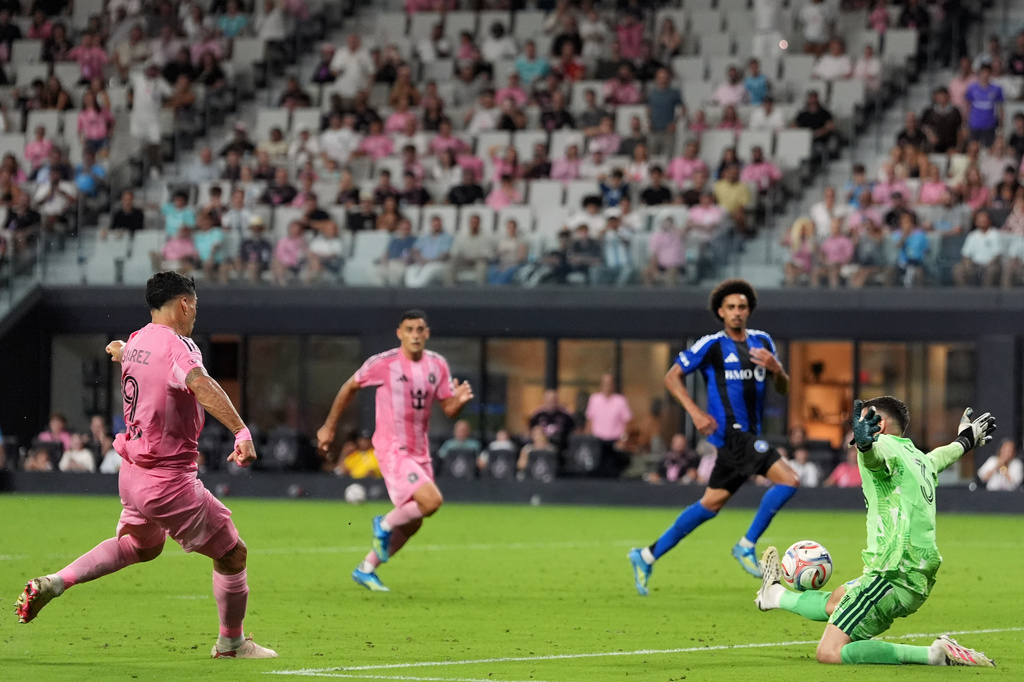 Inter Miami forward Luis Suarez scores his side's fourth goal past CF Montreal goalkeeper Thomas Gillier (31) during the second half of an MLS soccer match, Saturday, Aug. 29, 2026, in Miami. (AP Photo/Rebecca Blackwell)