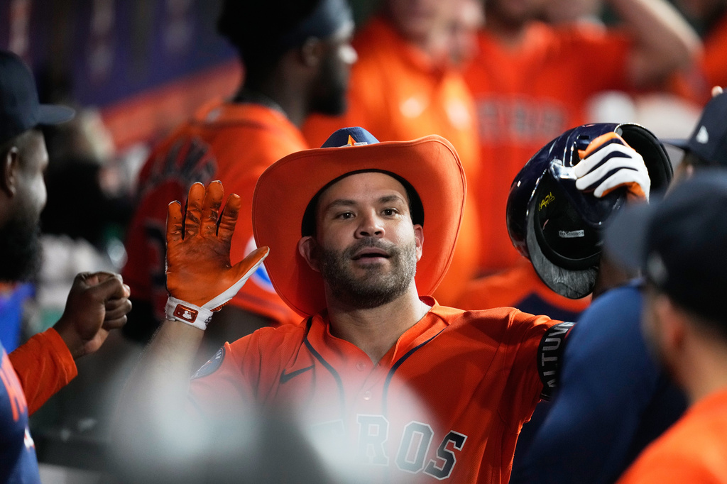 Houston Astros' Jose Altuve (27) celebrates in the dugout after hiting a home run during the fifth inning of a baseball game against the St. Louis Cardinals in Houston, Friday, April 17, 2026. (AP Photo/Ashley Landis)