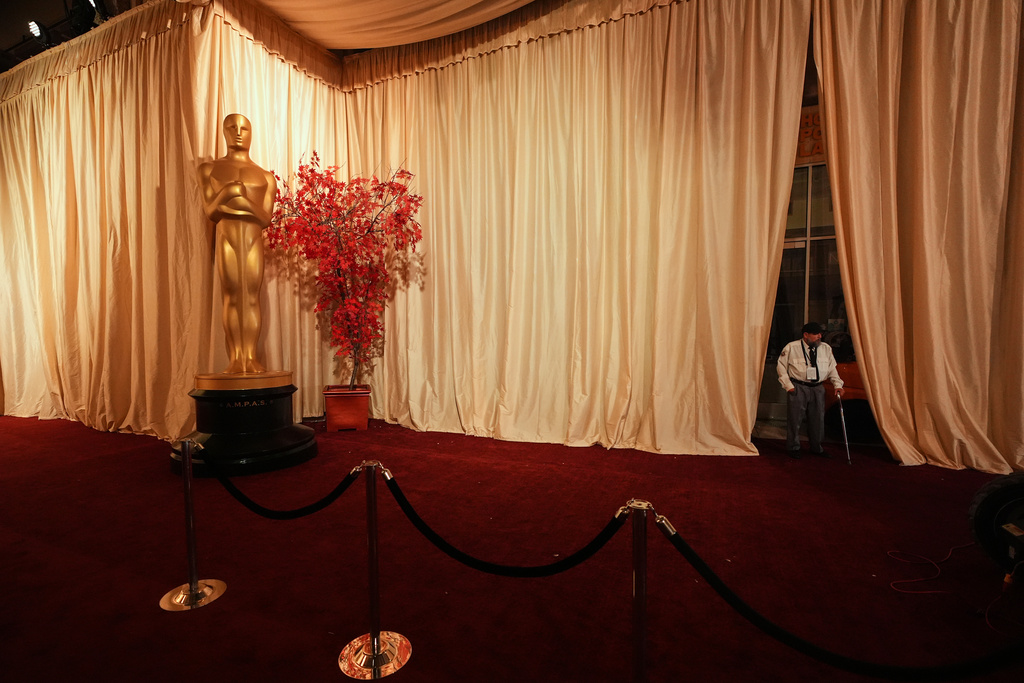 A security guard stands along an empty red carpet Saturday, March 14, 2026, at the Dolby Theatre in Los Angeles, the night before Sunday's 98th Academy Awards ceremony. (AP Photo/Gregory Bull)