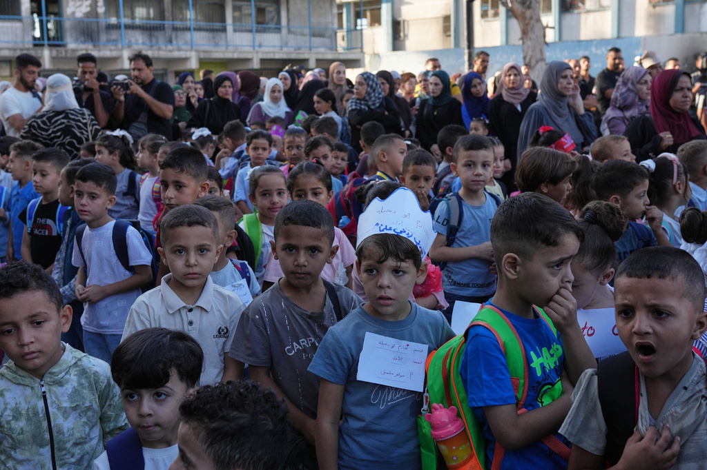 Palestinian children line up on the first day of the new academic year at an U.N.-run school in Nuseirat, central Gaza Strip, Saturday, Sept. 19, 2026. (AP Photo/Jehad Alshrafi)