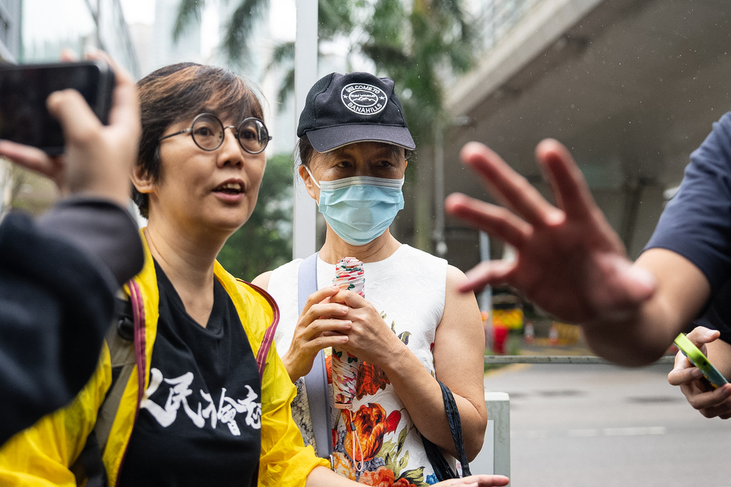 Medina Chow Lau Wah-chun, right, mother of pro-democracy activist Chow Hang-tung, leaves the West Kowloon Magistrates' Courts in Hong Kong, Friday, Aug. 21, 2026. (AP Photo/Chan Long Hei)