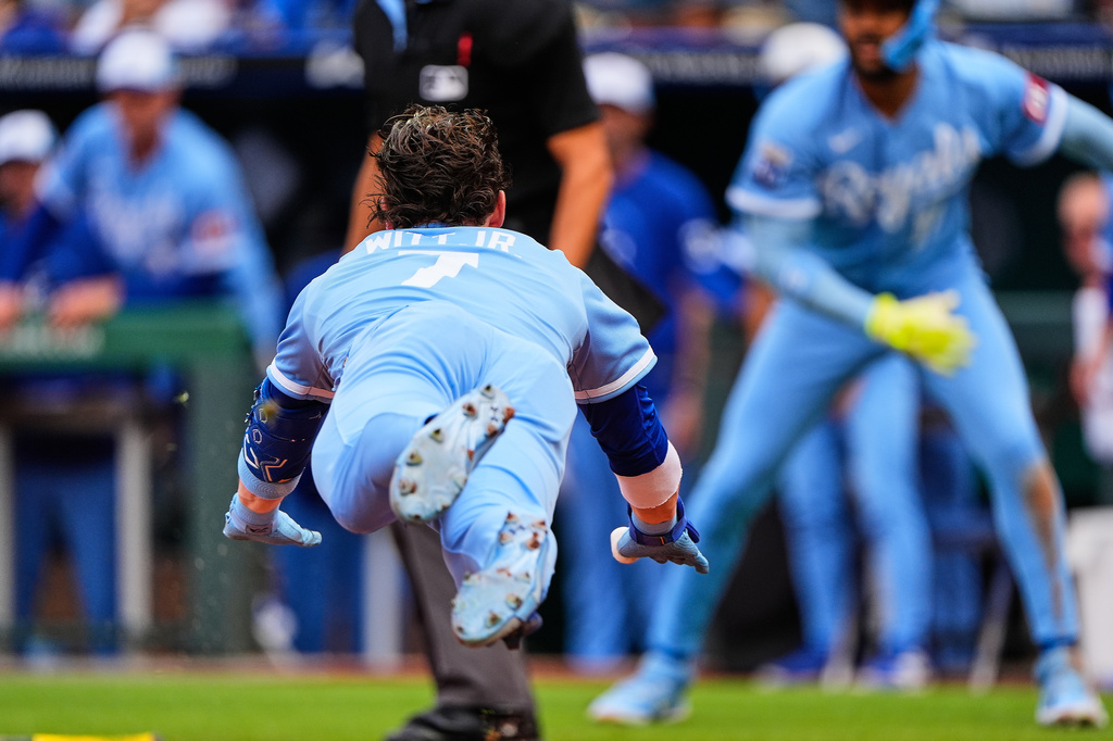 Kansas City Royals' Bobby Witt Jr. dives home to score after hitting a inside-the-park home run during the first inning of a baseball game against the Detroit Tigers, Saturday, May 9, 2026, in Kansas City, Mo. (AP Photo/Charlie Riedel)