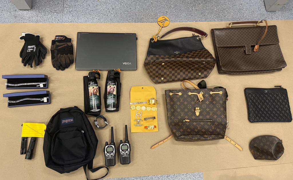 This undated photo provided by the Los Angeles Police Department shows firearms, cash, and stolen valuables recovered from an operation on Wednesday, Aug. 20, 2025, that led to the arrests of members of a burglary crew suspected of nearly 100 break-ins in the Los Angeles area. (LAPD via AP)