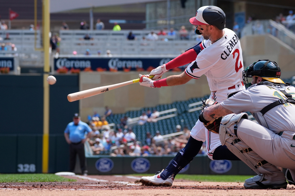 Minnesota Twins' Kody Clemens (2) hits an RBI triple against the Athletics in the first inning of a baseball game Sunday, July 26, 2026, in Minneapolis. Due to a throwing error, Clemens also scored on the play. (AP Photo/Bruce Kluckhohn)