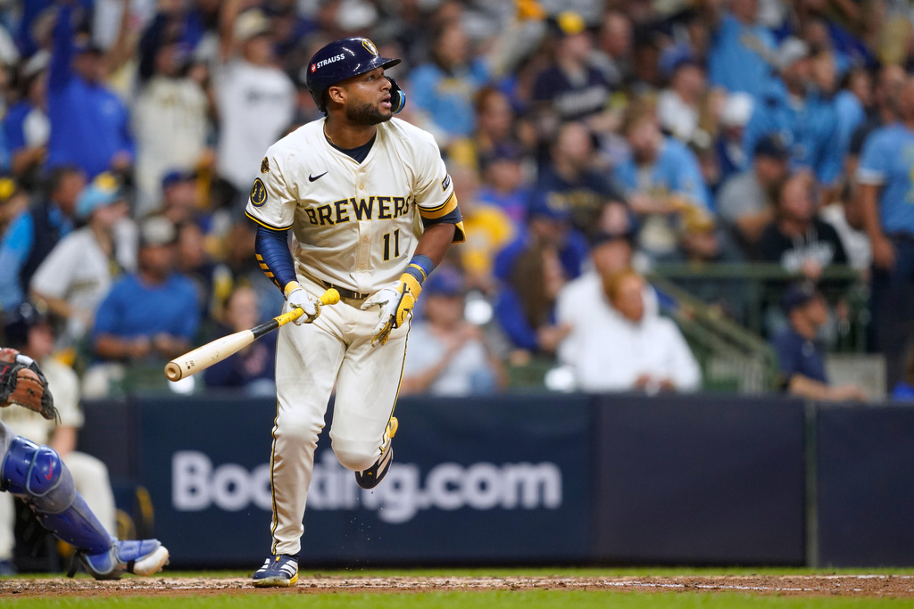 Milwaukee Brewers' Jackson Chourio (11) watches his 3-run home run during the fourth inning of Game 2 of baseball's National League Division Series against the Chicago Cubs Monday, Oct. 6, 2025, in Milwaukee. (AP Photo/Kayla Wolf)