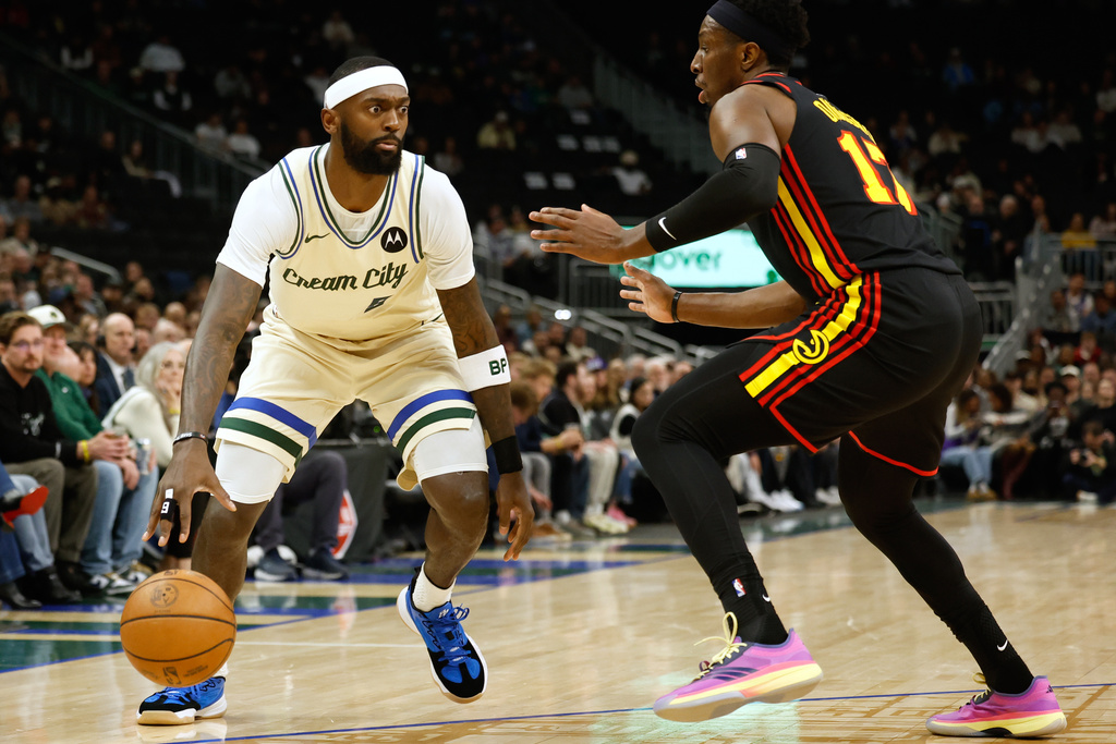 Milwaukee Bucks forward Bobby Portis (9) drives against the Atlanta Hawks' Onyeka Okongwu during the first half of an NBA basketball game, Wednesday, March 4, 2026, in Milwaukee. (AP Photo/Jeffrey Phelps)