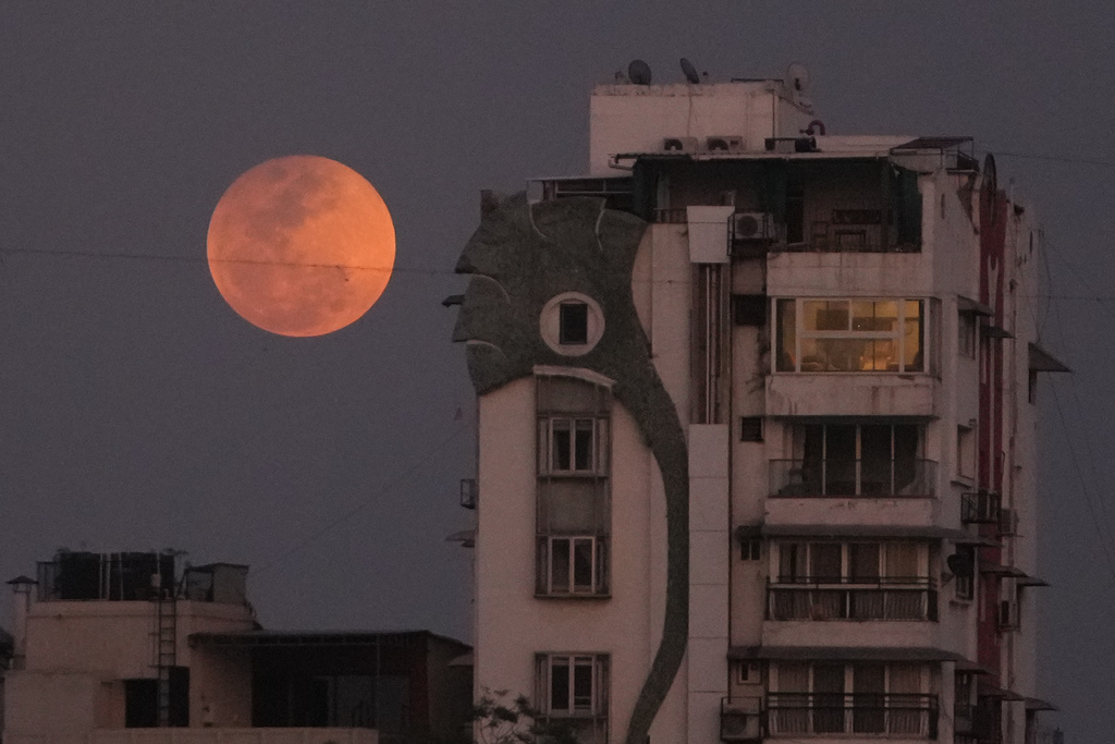 A blood moon rises over Ahmedabad, India, Tuesday, March 3, 2026. (AP Photo/Ajit Solanki)