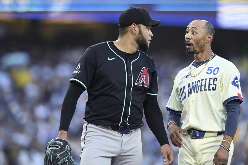 Arizona Diamondbacks pitcher Eduardo Rodriguez has a word with Los Angeles Dodgers baserunner Mookie Betts in the third inning of a baseball game Saturday, Aug. 30, 2025, in Los Angeles. (AP Photo/Wally Skalij)