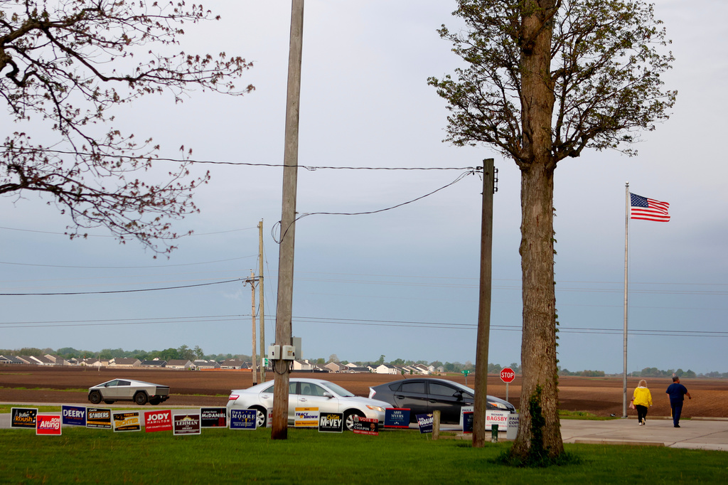 People walk into a vote center past signs for various local candidates during a primary election on Tuesday, May 5, 2026, in West Lafayette, Ind. (AP Photo/Cara Penquite)