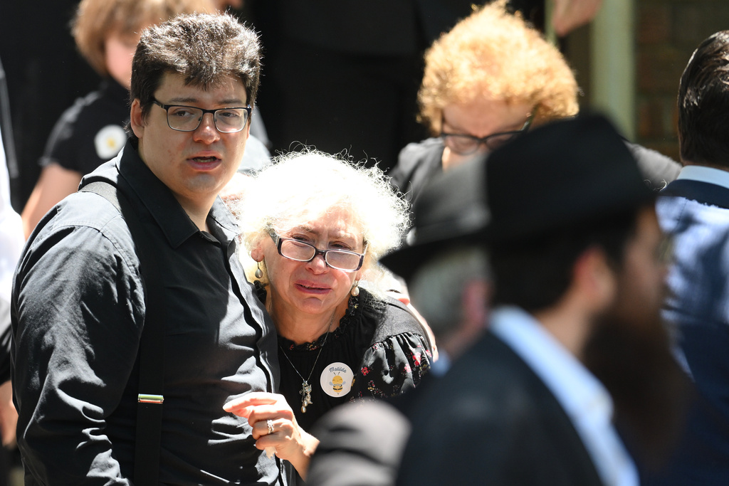 Mourners react at the funeral of Bondi Beach mass shooting victim 10-year-old Matilda, whose last name is being withheld at the request of her family, in Sydney, Thursday, Dec. 18, 2025. (AP Photo/Steve Markham)