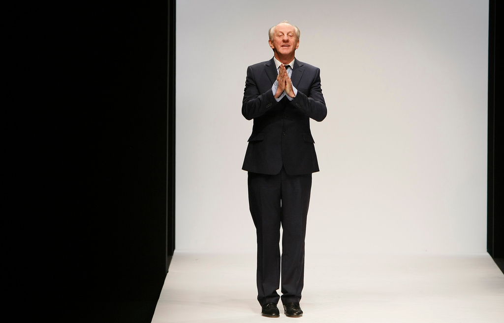 FILE - Designer Paul Costelloe reacts to the audience after his Autumn/Winter 2010 collection at London Fashion Week in London, Friday, Feb. 19, 2010.(AP Photo/Alastair Grant, File)