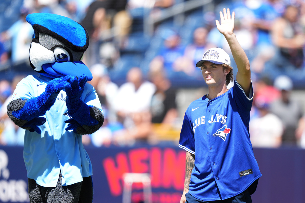 Gavin McKenna, first round pick for the Toronto Maple Leafs and first overall pick of the 2026 NHL draft, arrives to throw the ceremonial first pitch prior to the baseball game between the Toronto Blue Jays and the Texas Rangers, in Toronto, Saturday, June 27, 2026. (Nathan Denette /The Canadian Press via AP)