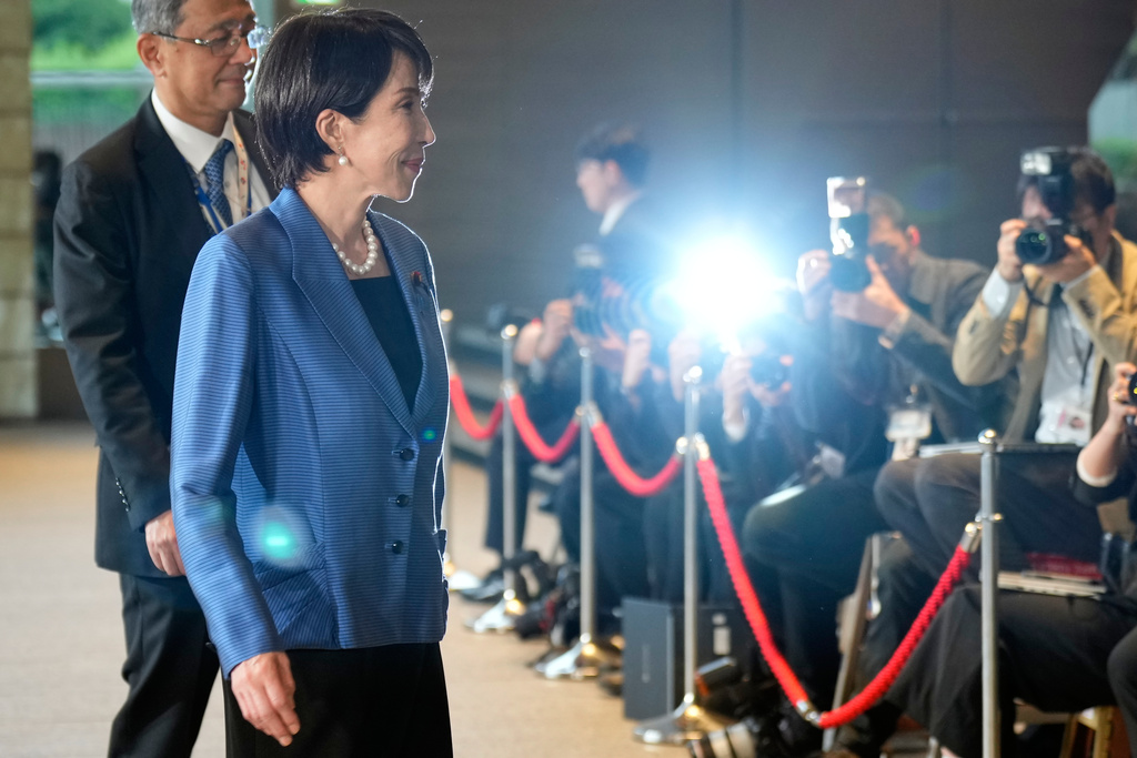 Japan's newly elected Prime Minister Sanae Takaichi, front, arrives at the prime minister's office in Tokyo, Japan, Tuesday, Oct. 21, 2025. (AP Photo/Eugene Hoshiko)