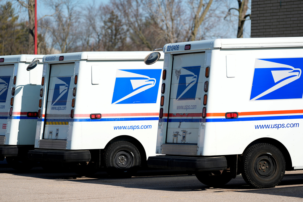 FILE - U.S. Postal Service trucks park outside a post office, Jan. 29, 2024, in Wheeling, Ill. (AP Photo/Nam Y. Huh, File)