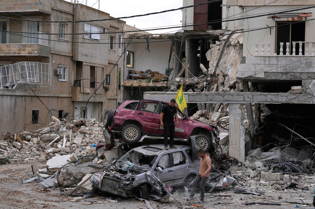 People check destroyed cars following a ceasefire between Israel and Hezbollah in the village of Maifadoun, southern Lebanon, Monday, June 22, 2026. (AP Photo/Mohammed Zaatari)