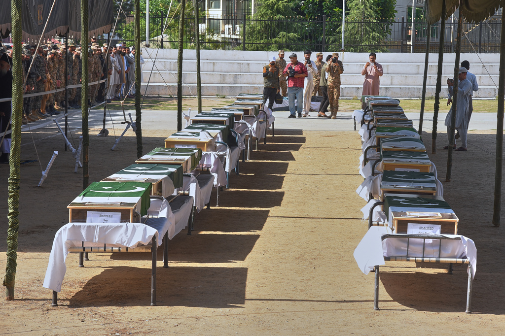 Military officers and civilians attend the funeral prayers of military personnel, killed in Wednesday's helicopter crash, during a funeral prayer, in Muzaffarabad, the capital of Pakistan-administered Kashmir, Thursday, June 11, 2026. (AP Photo/M.D. Mughal)