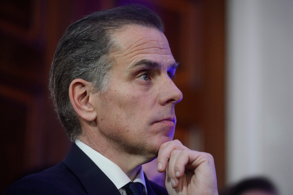 FILE - Hunter Biden listens while his father, President Joe Biden, speaks during a Hanukkah reception in the East Room of the White House in Washington, Dec. 16, 2024. (AP Photo/Rod Lamkey, Jr., File)