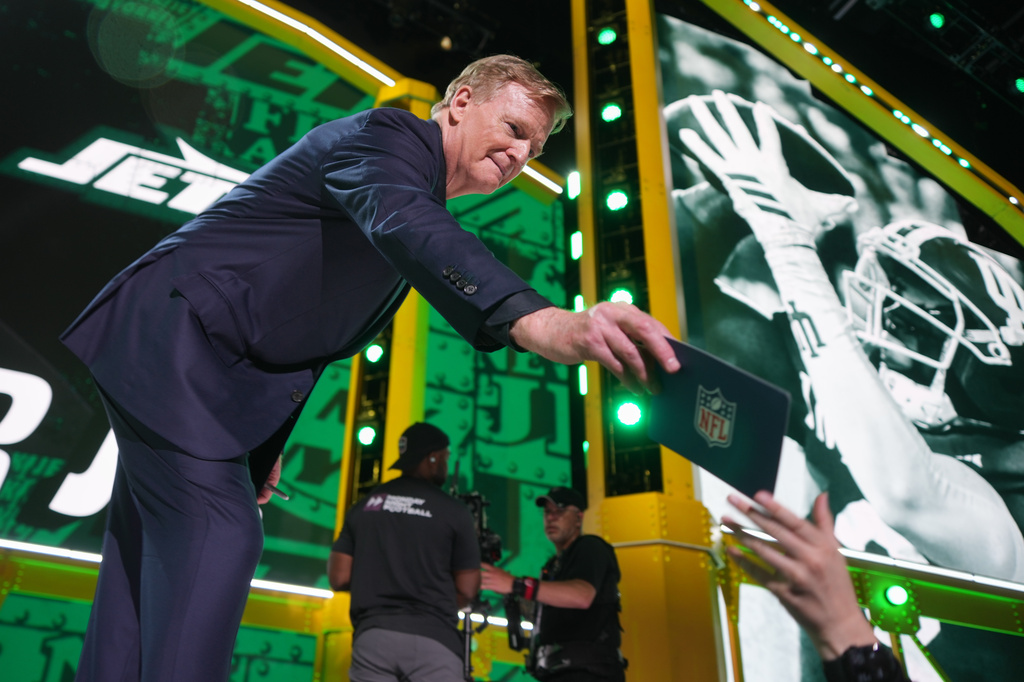 NFL Commissioner Roger Goodell hands out a card from the stage during the first round of the NFL football draft, Thursday, April 23, 2026, in Pittsburgh. (AP Photo/Gene J. Puskar)