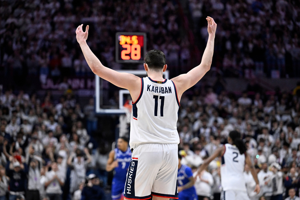 UConn forward Alex Karaban (11) raises his arms in the first half of an NCAA college basketball game against Seton Hall, Saturday, Feb. 28, 2026, in Storrs, Conn. (AP Photo/Jessica Hill)