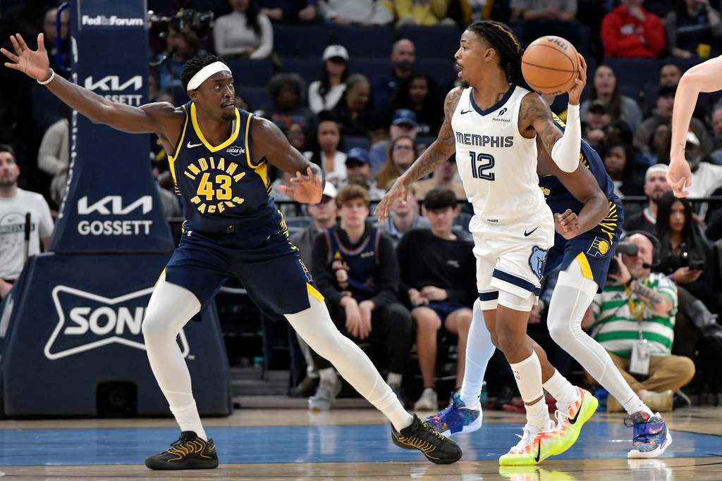 Memphis Grizzlies guard Ja Morant (12) handles the ball against Indiana Pacers forward Pascal Siakam (43) in the first half of an NBA basketball game, Saturday, Oct. 25, 2025, in Memphis, Tenn. (AP Photo/Brandon Dill)