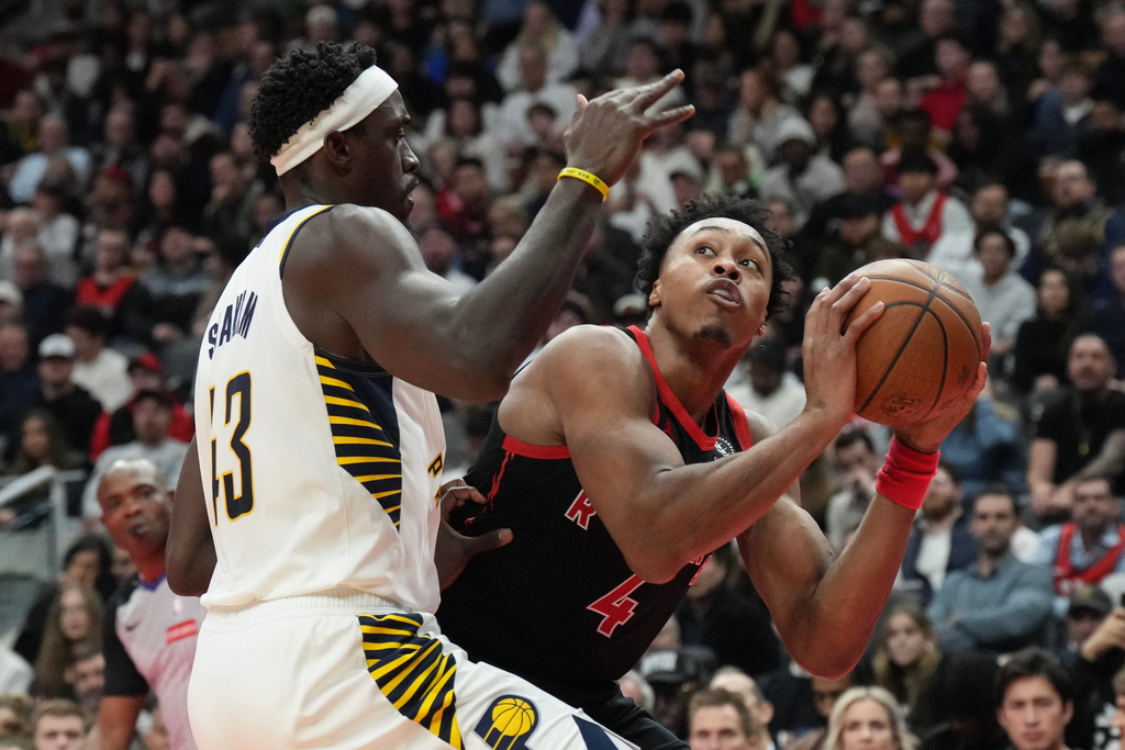 Toronto Raptors forward Scottie Barnes (4) looks to shoot on Indiana Pacers forward Pascal Siakam (43) during first half NBA Cup basketball action in Toronto on Wednesday, Nov. 26, 2025. (Chris Young/The Canadian Press via AP)