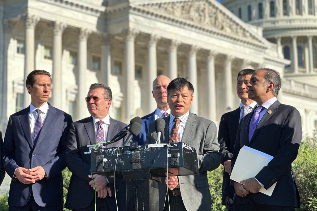 ADDS NAMES - Flanked by U.S. lawmakers and supporters, Arthur Liu, father of U.S. figure skater Alysa Liu and a former student leader during the 1989 Tiananmen Movement, speaks at an event at the U.S. Capitol, Thursday, June 4, 2026, in Washington, commemorating the 37-year anniversary of the Tiananmen Movement crackdown, as from left, Poland politician Kacper Płażyński, Albania politician Fatmir Mediu, Rep. John Moolenaar, R-Mich., Zhou Fengsuo and Rep. Raja Krishnamoorthi, D-Ill., far right, look on. (AP Photo/Didi Tang)
