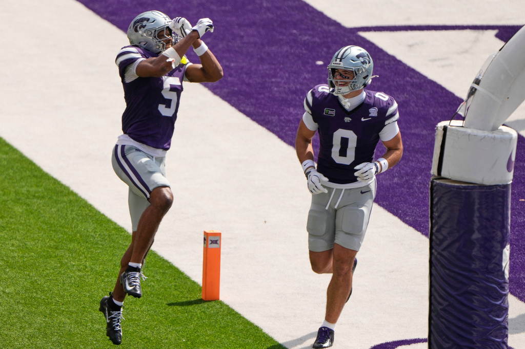 Kansas State wide receiver Josh Manning (5) celebrates with tight end Linkon Cure (0) after scoring a touchdown during the first half of an NCAA college football game against Washington State, Saturday, Sept. 12, 2026, in Manhattan, Kan. (AP Photo/Charlie Riedel)