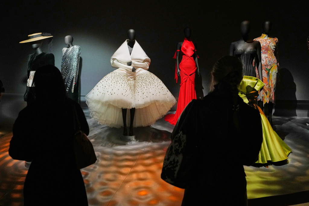 Visitors view dresses during the press preview for Schiaparelli: Fashion Becomes Art exhibition at the V&A museum in London, Wednesday, March 25, 2026. (AP Photo/Kirsty Wigglesworth)