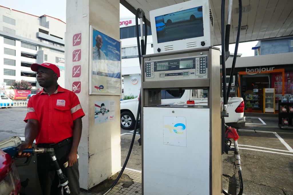 A service employee is filling a car with fuel at a petrol station in Lagos, Nigeria, Monday, March 23, 2026. (AP Photo/Sunday Alamba)