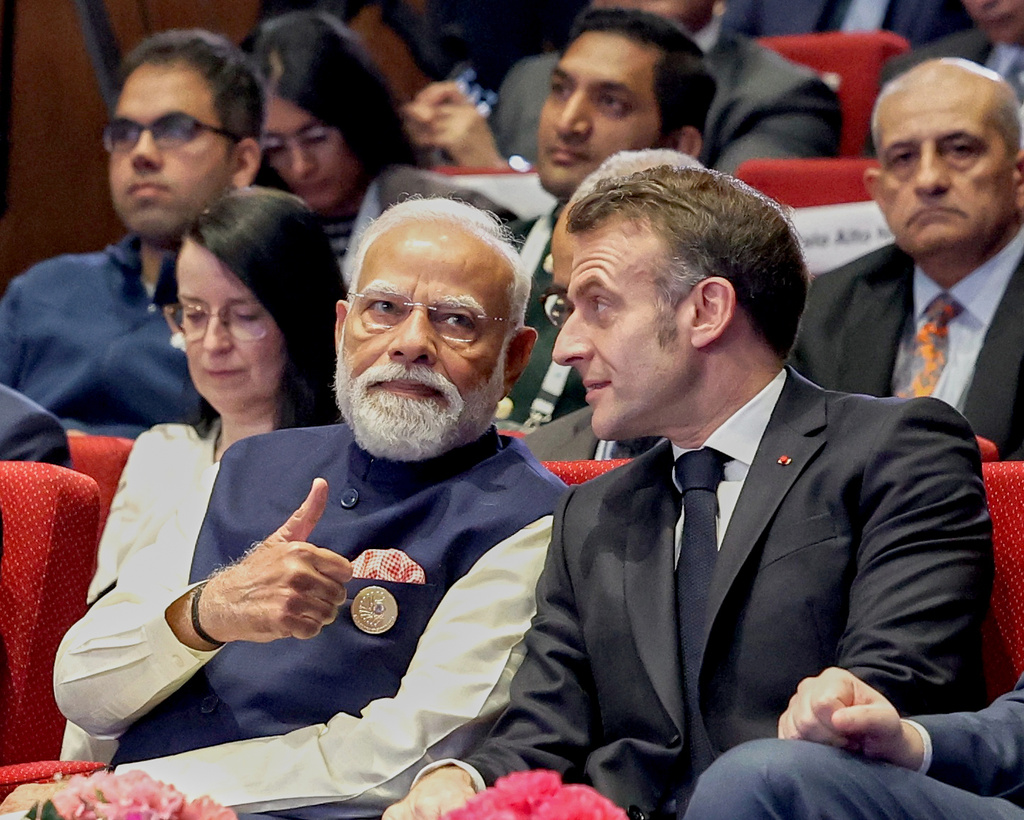 India's Prime Minister Narendra Modi, left, talks with French President Emmanuel Macron during the AI Summit in New Delhi, India, Thursday, Feb.19, 2026. (Indian Prime Minister's Office via AP)