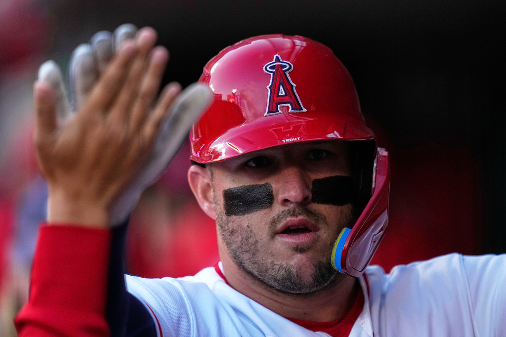 Los Angeles Angels' Mike Trout is congratulated by teammates in the dugout after hitting a solo home run during the first inning of a baseball game against the Chicago White Sox, Tuesday, May 5, 2026, in Anaheim, Calif. (AP Photo/Mark J. Terrill)