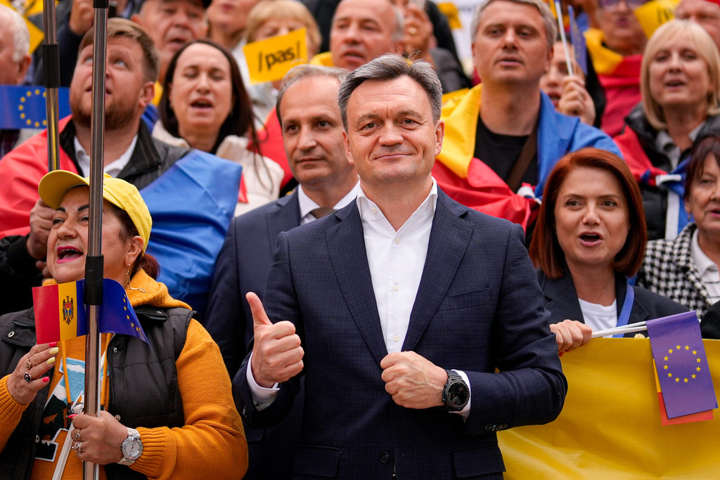 Moldova's Prime Minister Dorin Recean flashes a thumbs up next to supporters during a pro-EU rally of the ruling Party of Action and Solidarity (PAS), in Chisinau, Moldova, Friday, Sept. 26, 2025, ahead of parliamentary elections taking place on Sept. 28. (AP Photo/Vadim Ghirda)