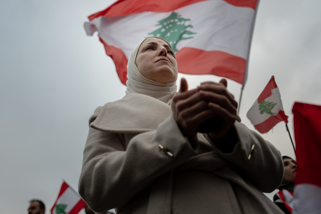 A woman holds a candle during a vigil for people killed in Lebanon during the Iran war, Friday, April 10, 2026, in Dearborn, Mich. (AP Photo/Julia Demaree Nikhinson)