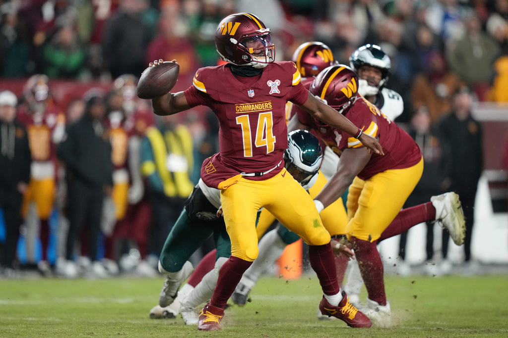 Washington Commanders quarterback Josh Johnson looks to pass the ball against the Philadelphia Eagles during the second half of an NFL football game, Saturday, Dec. 20, 2025, in Landover, Md. (AP Photo/Stephanie Scarbrough)