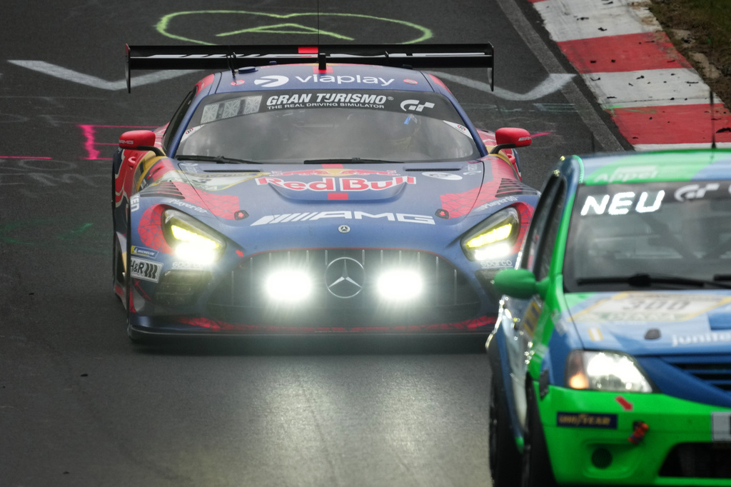 Max Verstappen, driving the Red Bull Mercedes AMG GT3, flashes his his headlights as he demands a clear path from a slower vehicle during the Nurburgring 24-hour auto race in Nurburg, Germany, Saturday May 16, 2026. (Thomas Frey/dpa via AP)