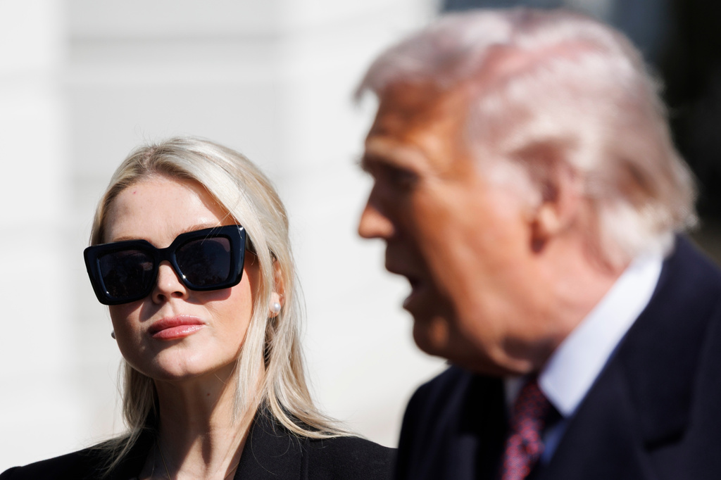 FILE - Press Secretary Karoline Leavitt glances at President Donald Trump before departing on Marine One from the South Lawn of the White House, Feb. 27, 2026, in Washington. (AP Photo/Tom Brenner, File)