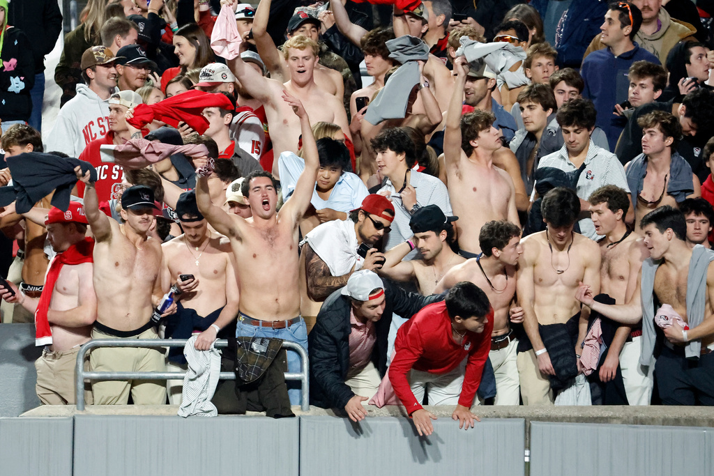 North Carolina State fans prepare to rush the field following an NCAA college football game between North Carolina State and Georgia Tech in Raleigh, N.C., Saturday, Nov. 1, 2025. (AP Photo/Karl DeBlaker)