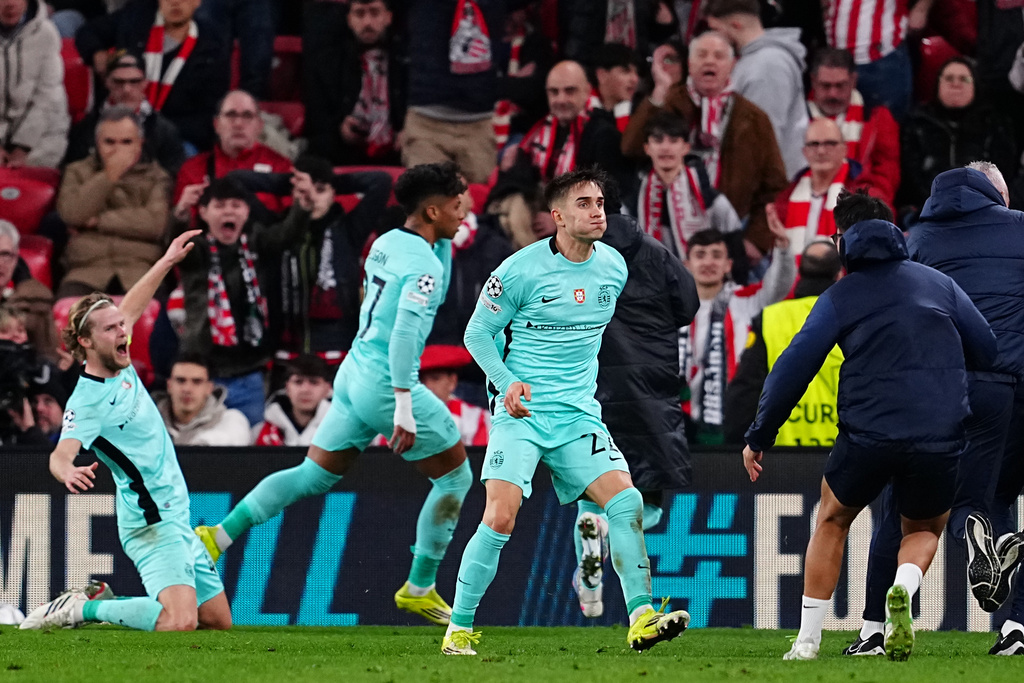 Sporting's Ivan Fresneda, front, celebrates after Alisson Santos scoring the third goal during the Champions League opening phase soccer match between Athletic Bilbao and Sporting CP, in Bilbao, Spain, Wednesday, Jan. 28, 2026. (AP Photo/Miguel Oses)