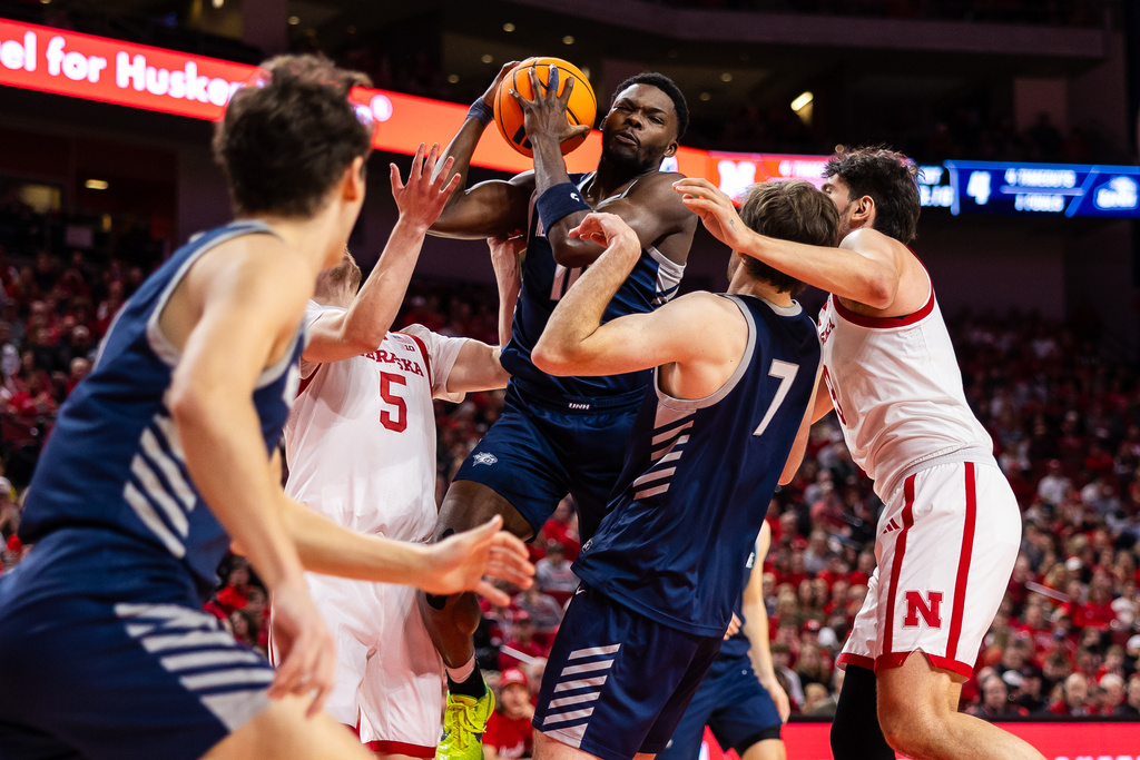 New Hampshire guard Comeh Emuobor (10) pulls down a rebound against Nebraska during the first half of an NCAA college basketball game, Tuesday, Dec. 30, 2025, in Lincoln, Neb. (AP Photo/Bonnie Ryan)
