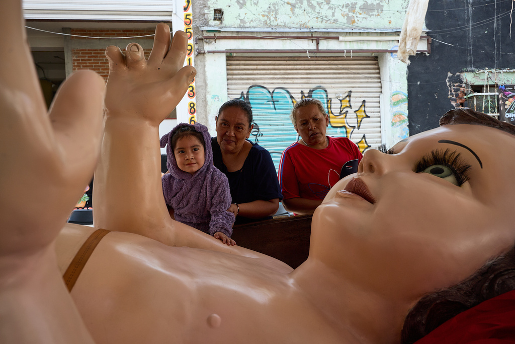 Parishioners take part in an offering to a giant Baby Jesus in Mexico City, Tuesday, March 10, 2026. (AP Photo/Ginnette Riquelme)