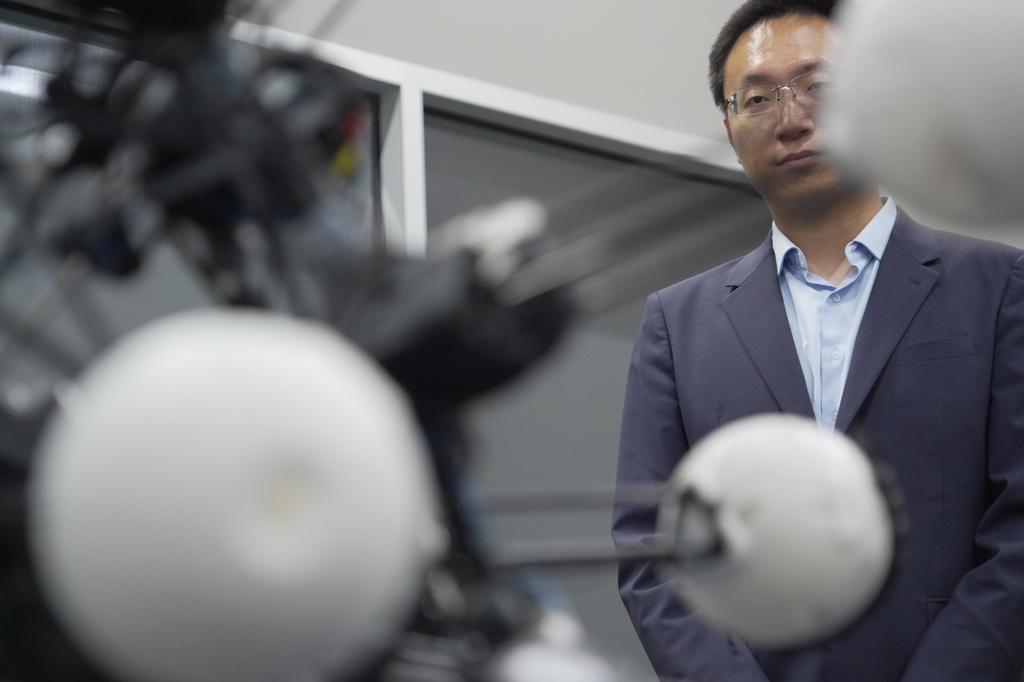Professor Boyuan Chen watches as a robot named Argus expands and contract at Duke University's General Robotics Lab in Durham, N.C., Tuesday, May 26, 2026. (AP Photo/Allen G. Breed)