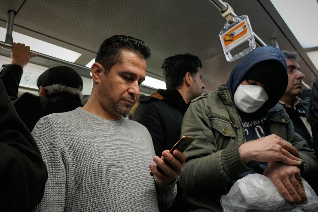 FILE - A man uses his smartphone while riding the subway in Tehran, Iran, Tuesday, Dec. 24, 2024. (AP Photo/Vahid Salemi, File)