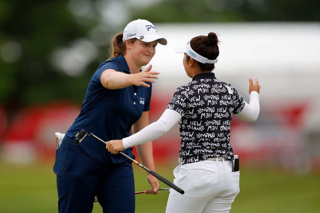 Lottie Woad, of England, left, and Miyu Yamashita, right, of Japan, embrace on the 18th hole after a playoff in the final round of the Meijer LPGA Classic golf tournament, Sunday, June 21, 2026, in Belmont, Mich. (AP Photo/Al Goldis)