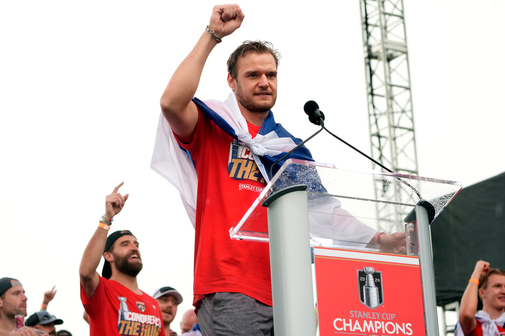 FILE - Florida Panthers' Aleksander Barkov, front, gestures while speaking during an NHL hockey rally and parade to celebrate the NHL hockey team winning the Stanley Cup, Sunday, June 30, 2024, in Fort Lauderdale, Fla.. (AP Photo/Marta Lavandier, File)